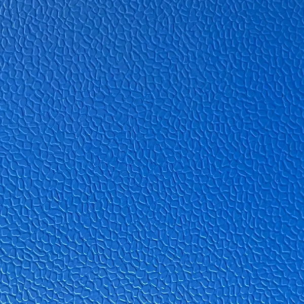Close-up view of three-dimensional stone pattern surface texture on pickleball flooring