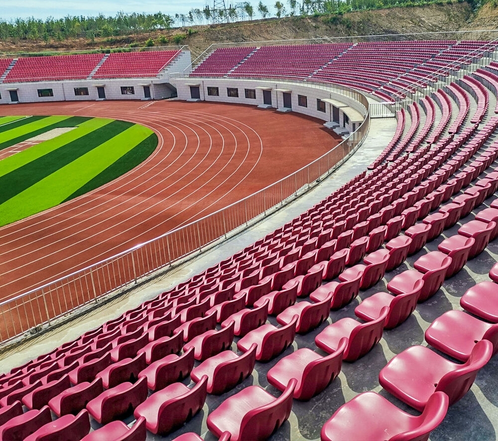 Side-by-side material comparison of Eco-M HDPE 5502 blow molded stadium seat versus polypropylene stadium seat, showing shell wall section, surface finish, color saturation, and structural profile differentiation