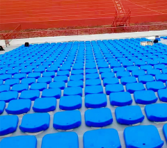 Municipal auditorium fixed-row seating installation featuring Chang-L HDPE hollow blow molded seats, showing flat installation configuration, color layout across seating rows, and structural integration with auditorium floor-mount frame system