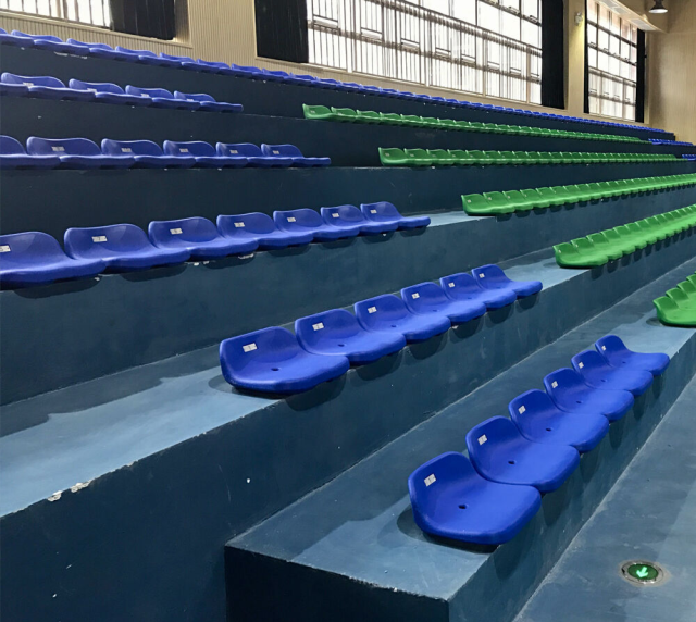 Side-by-side material comparison of HDPE 5502 blow molded stadium seat versus polypropylene stadium seat, showing structural wall profile, surface finish, and color differentiation