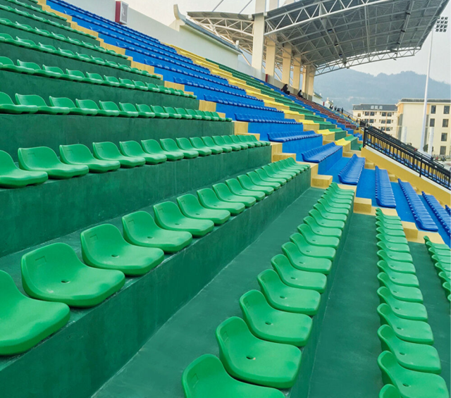 HDPE blow molded stadium seats installed in flat installation configuration on a fixed bleacher deck row, showing seat-to-frame mounting profile and row alignment geometry