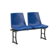 Stadium seat with integrated armrest, cupholder, and mechanical writing board optional accessories installed, showing accessory configuration on contoured bucket seat body in outdoor sports venue or multi-use arena context