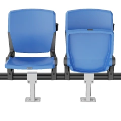 stadium seat with integrated armrest and integrated cupholder accessories installed, showing optional accessory configuration close-up detail on PP gas-assisted injection molded seat body in bleacher row context
