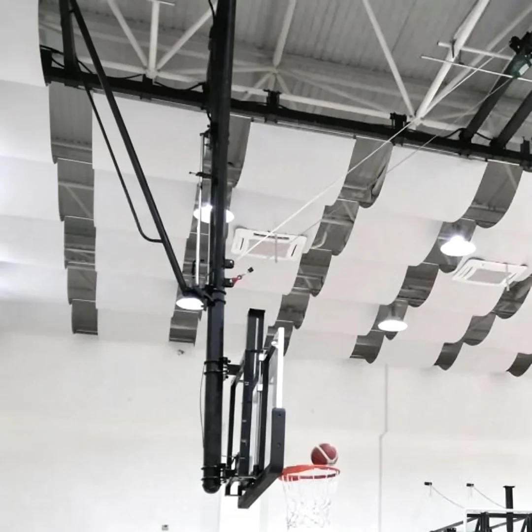 Full professional arena or stadium installation of FIBA certified ceiling suspended backstop showing ceiling suspension mounting configuration, 5½" drop frame at operational play height below up-to-40' ceiling span, and multi-unit court layout in basketball stadium or university arena context