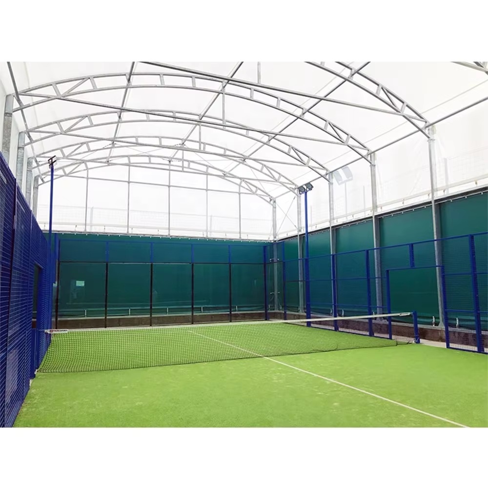 Padel court H007R simple roof steel structure assembly showing hot dip galvanized roof rafter and purlin framing, roof-to-court perimeter frame integration at foundation anchor points, and structural steel canopy geometry above 20×10m court footprint during installation phase