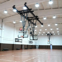 Ceiling suspension basketball rack showing smooth electric winch mechanism and high-strength safety belt system close-up, illustrating winch drive assembly, safety belt reel and attachment point, and overhead ceiling mounting hardware interface for height adjustment and fail-safe descent arrest