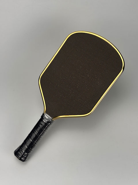 High-definition face close-up showing custom logo application via industrial UV print/custom surface finish system on the TITANIUM Pickleball Paddle face plate.