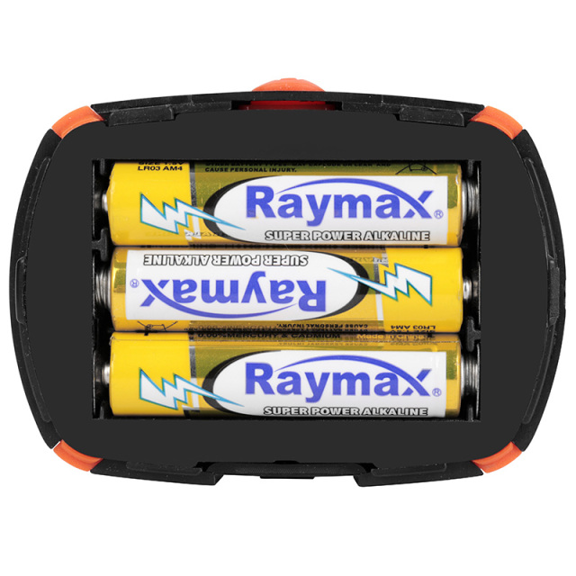 Internal view of the battery compartment for 3x AAA batteries in the orange COB headlamp.