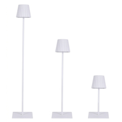 Minimalist white rechargeable lamp with pleated design and modular height segments for hotel lighting projects.