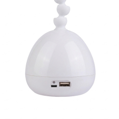 Detail of dual power LED desk lamp with USB DC port and 18650 battery compartment for continuous use.