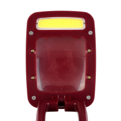Side profile of the burgundy lamp in its compact folded position.