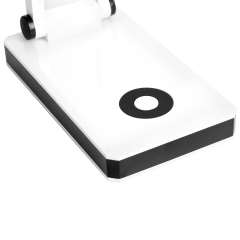 Sensitive touch sensor switch on the base of a minimalist LED desk lamp for modern offices.