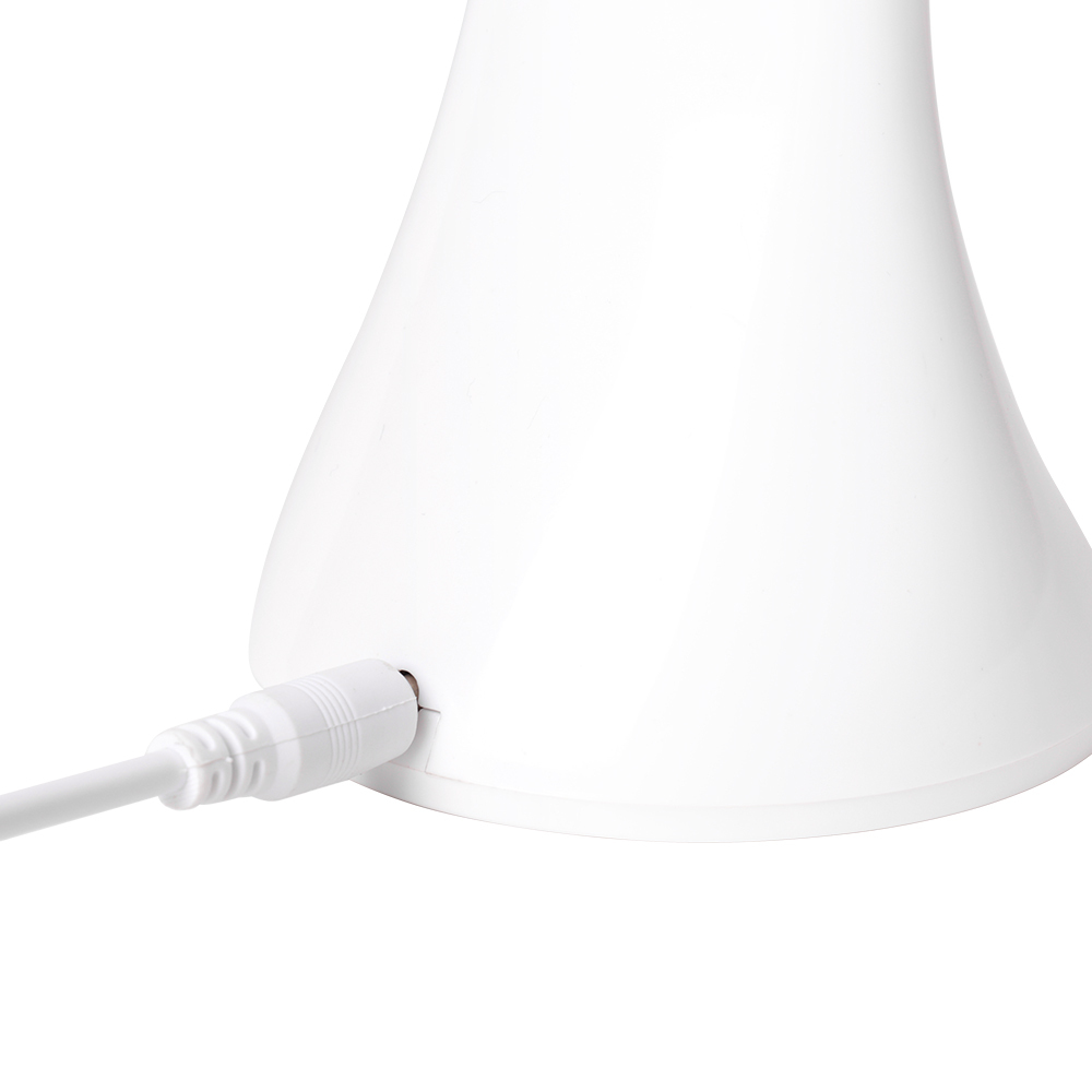 Close up of the USB charging cable connected to the white folding desk lamp
