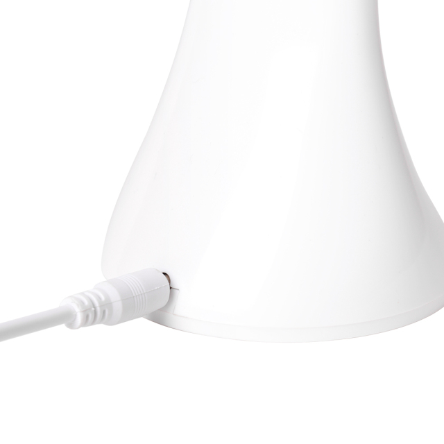 Close up of the USB charging cable connected to the white folding desk lamp