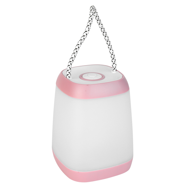 Three-quarter studio view from above showing the top push button switch of a pink portable night light
