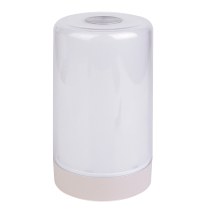 Three-quarter studio view of a modern cylindrical touch-activated LED bedside light against a white background