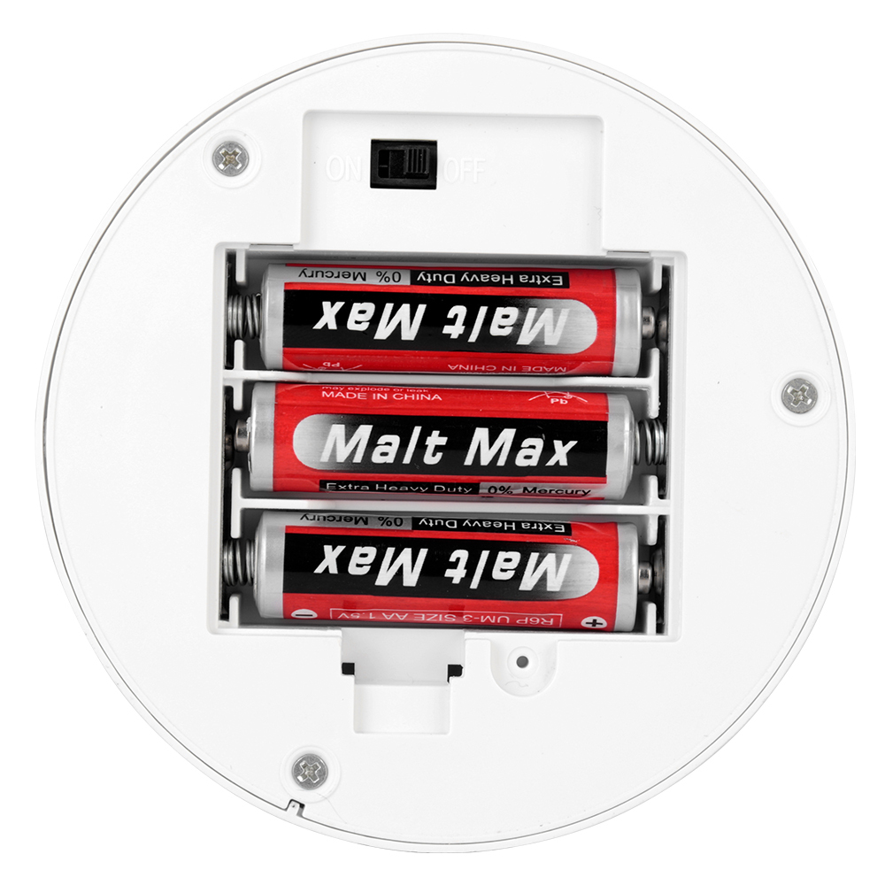 Close-up shot of the opened battery compartment housing three AA batteries on the bottom of the lamp base