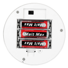 Close-up shot of the opened battery compartment housing three AA batteries on the bottom of the lamp base
