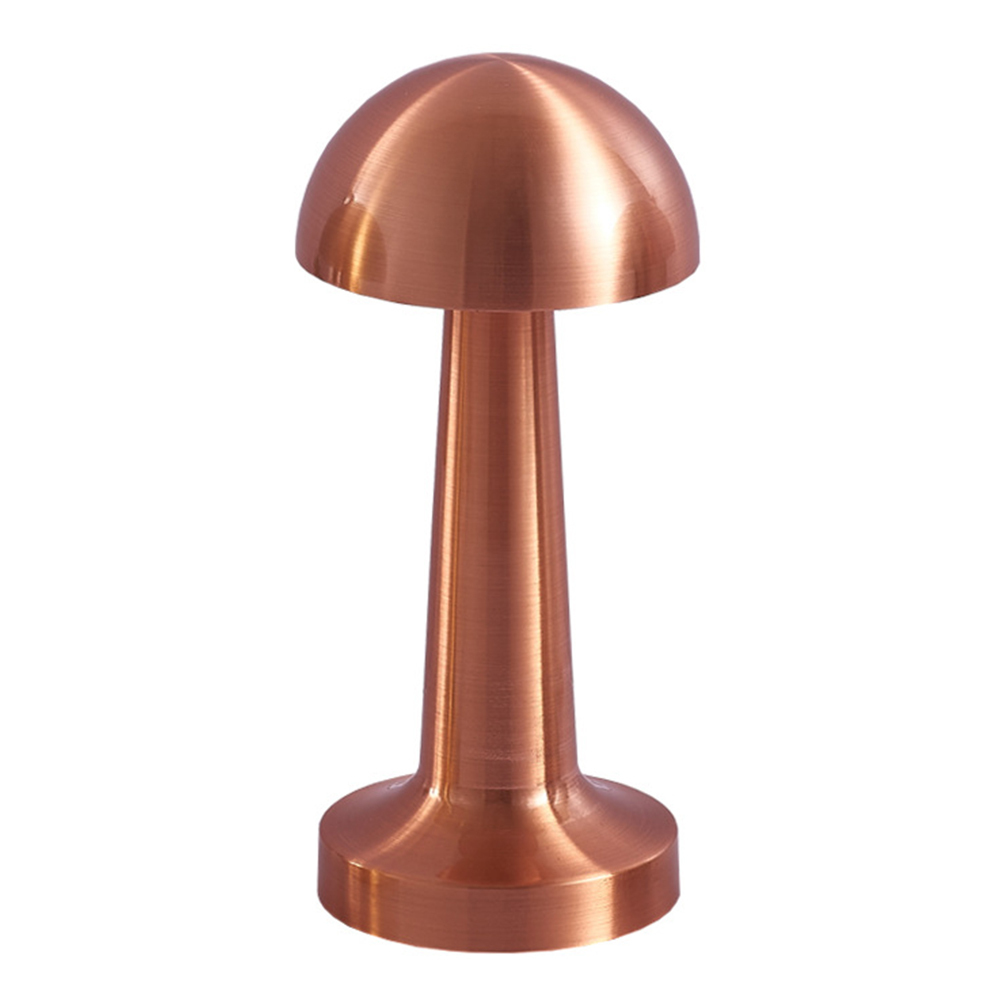 Front studio view of a brushed copper metal mushroom-shaped cordless table lamp on a white background