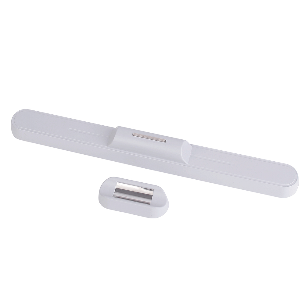 Studio photograph showing the white reading light bar detached from its small separate magnetic wall mount base