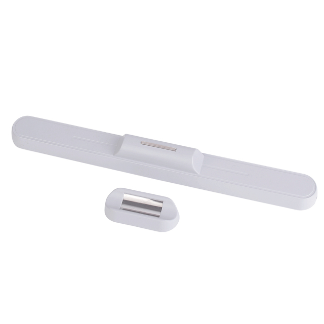 Studio photograph showing the white reading light bar detached from its small separate magnetic wall mount base