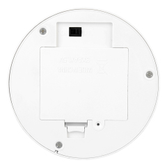 Bottom view of the circular neon table lamp base showing the smooth closed plastic compartment cover and power switch
