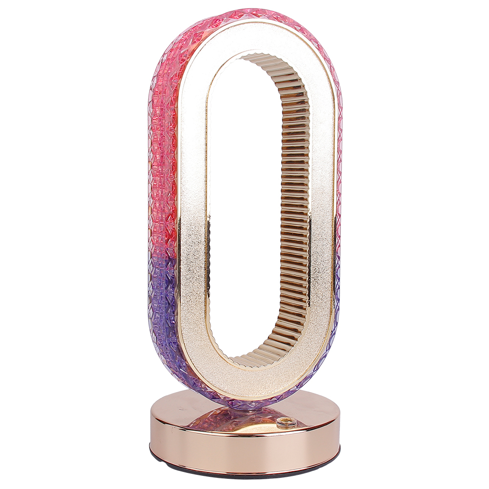 Front three-quarter studio view of an oval cordless crystal table lamp with a rose gold base and pink-purple gradient on a white background
