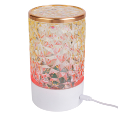 Rear side studio view of a rechargeable crystal table lamp showing a power cable connected to its charging port