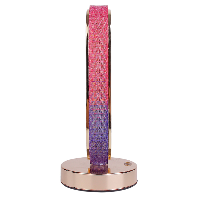 Profile studio view of a slim oval crystal desk lamp highlighting the textured diamond pattern and pink-purple gradient finish