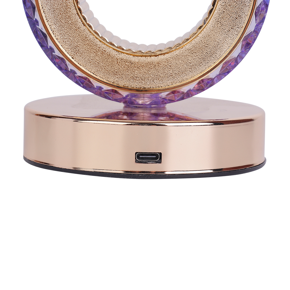 Close-up studio view of the Type-C USB charging interface on the polished rose gold metal base of a crystal table lamp