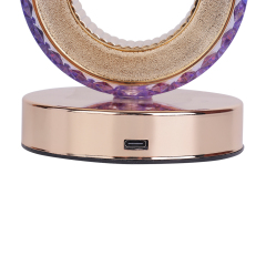 Close-up studio view of the Type-C USB charging interface on the polished rose gold metal base of a crystal table lamp