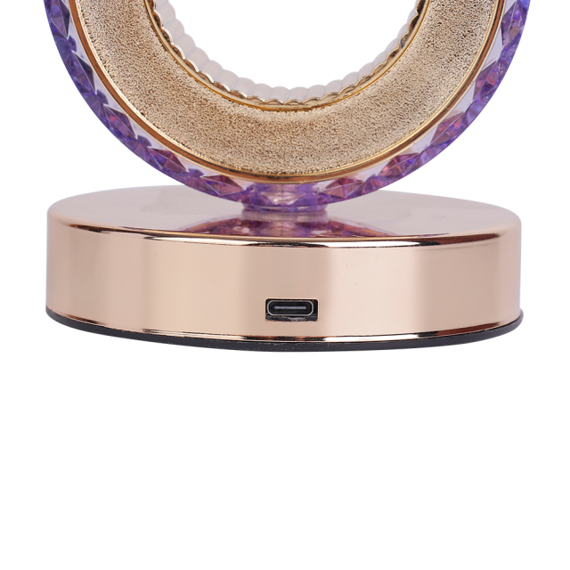 Close-up studio view of the Type-C USB charging interface on the polished rose gold metal base of a crystal table lamp