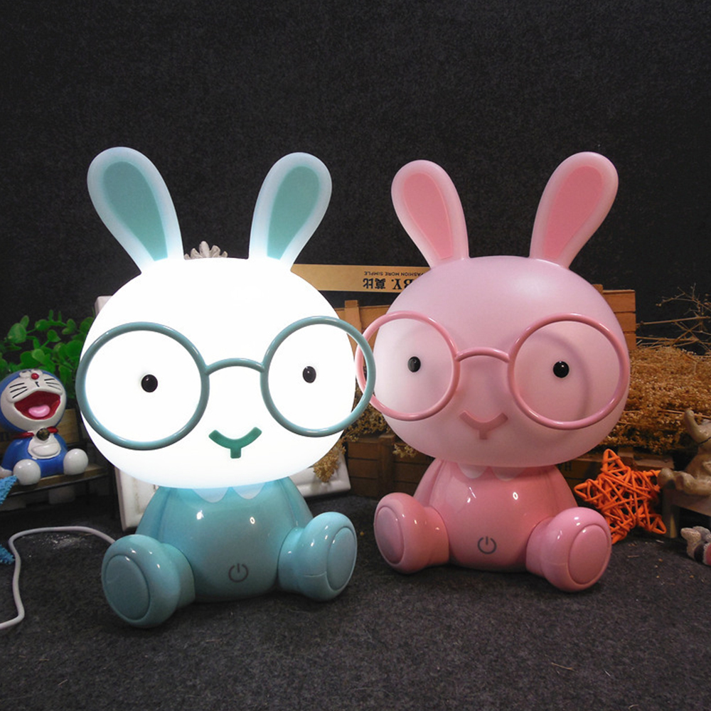 A blue rabbit night light glowing white and a pink rabbit night light glowing pink displayed together for wholesale sourcing