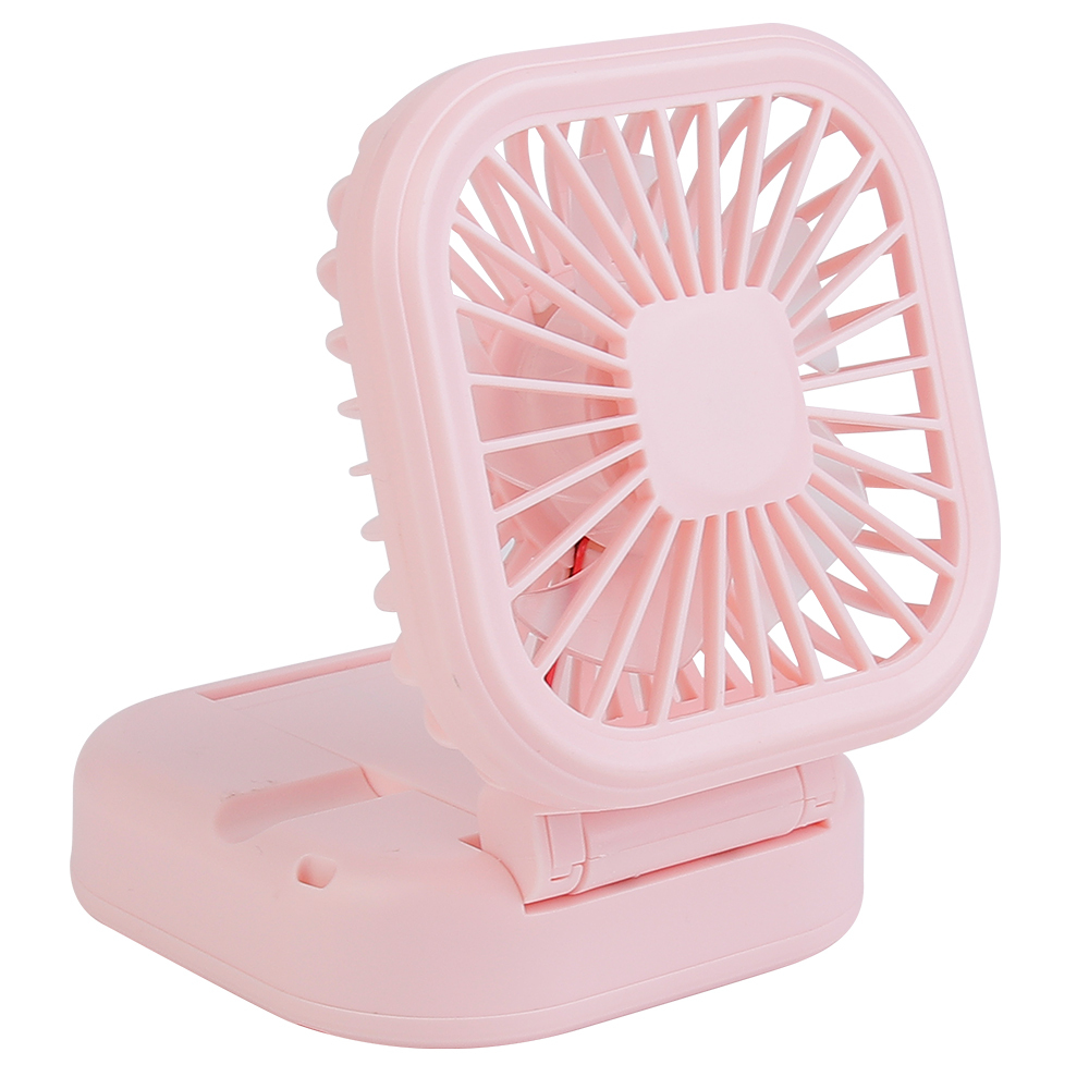 Three-quarter angled studio view of the pink mini table fan showing its square head and integrated phone holder base groove.