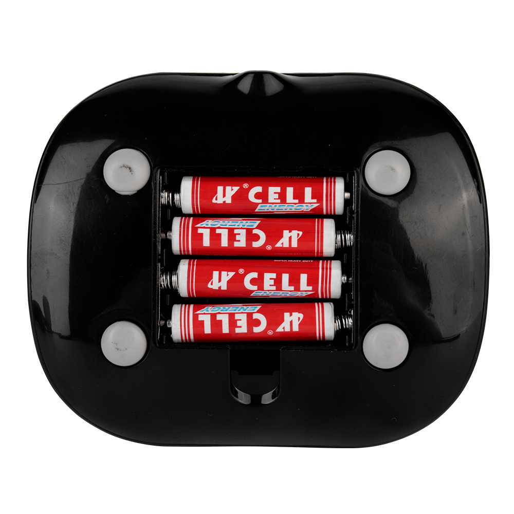 Bottom view of the desktop fan base showing three AAA batteries installed inside the uncovered battery compartment.