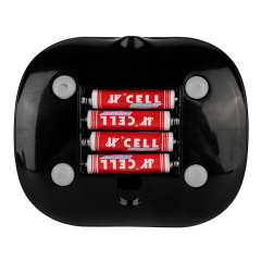 Bottom view of the desktop fan base showing three AAA batteries installed inside the uncovered battery compartment.