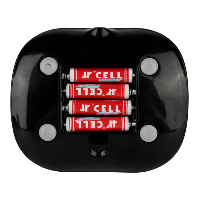 Bottom view of the desktop fan base showing three AAA batteries installed inside the uncovered battery compartment.