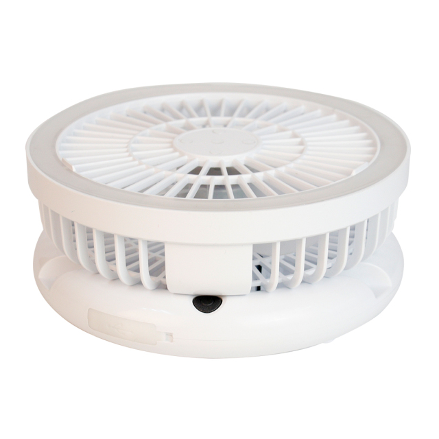 Side studio view of the white collapsible travel fan completely folded down into a compact cylindrical shape.