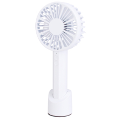 Three-quarter angled front studio view of the cordless white desk fan secured in its removable base.