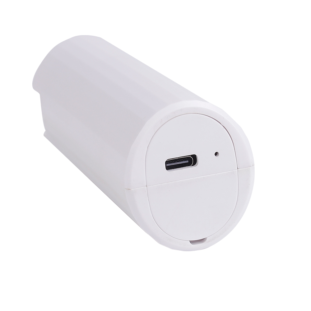 Close-up studio view of the bottom of the white cylinder pocket fan showing the USB-C charging port.
