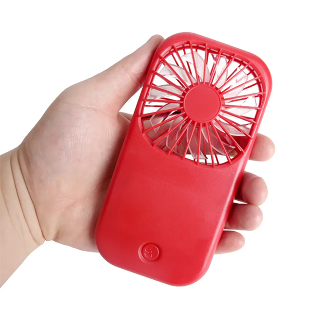 A hand holding the ultra-compact red pocket fan against a white background to demonstrate its portable size.