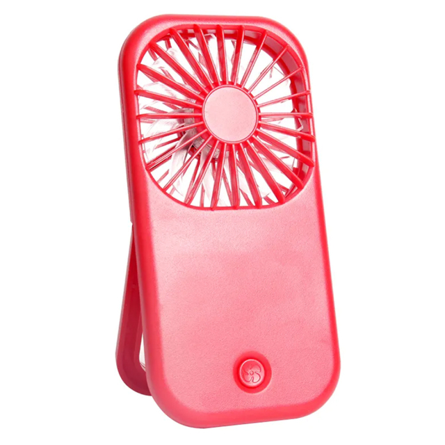 Three-quarter angled front studio view of the red foldable desk fan with its integrated back bracket unfolded as a stand.