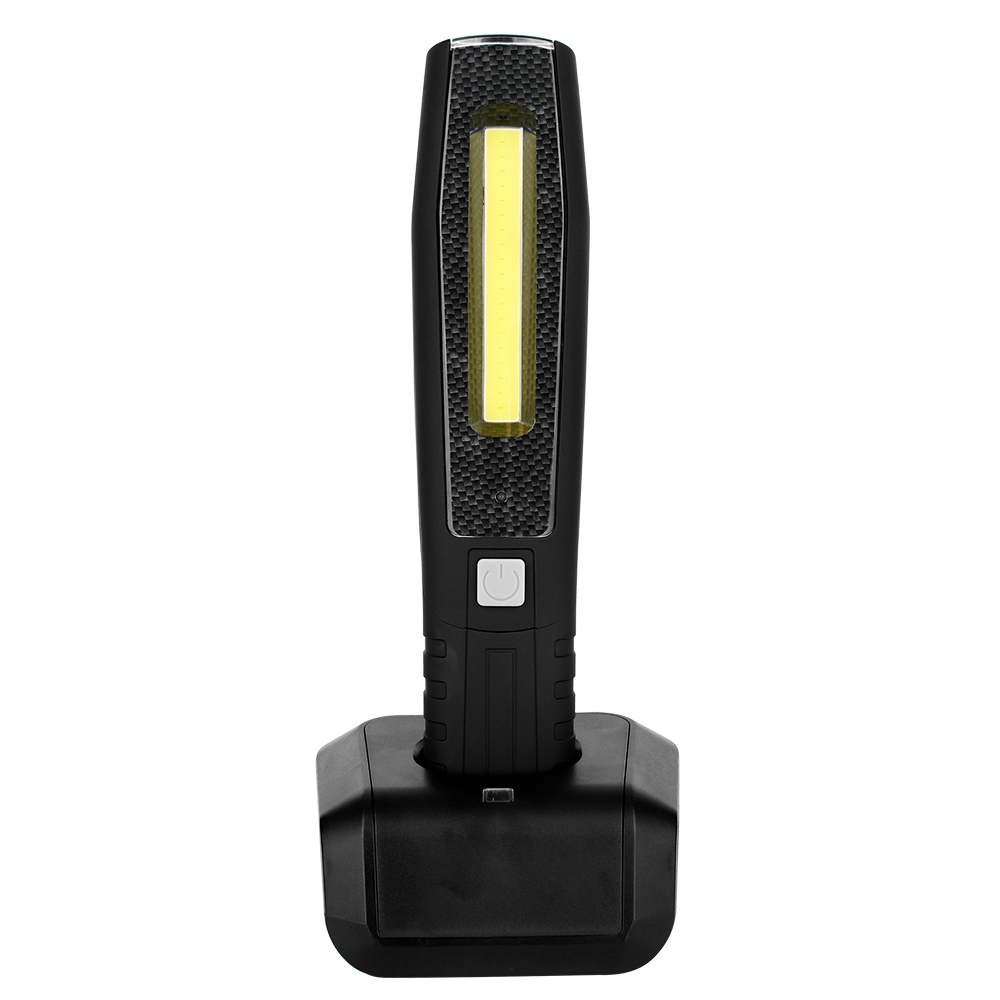Front view of a black magnetic COB LED work light sitting vertically inside its charging base.