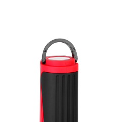 Close-up view of the integrated fold-out hanging hook on top of the red portable LED work light.