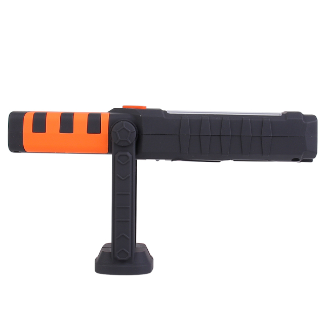 Side view of the magnetic LED work light demonstrating its 180-degree rotating base mechanism on a flat surface.