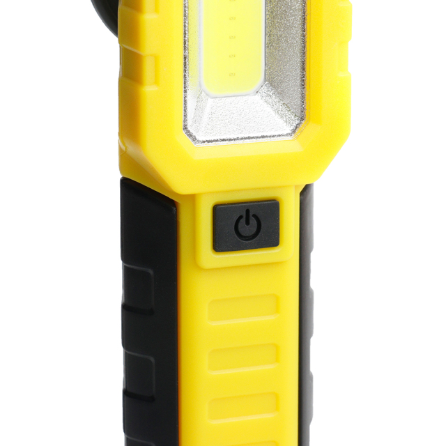 Close-up view of the side-mounted black silicone power switch button on the yellow plastic casing.