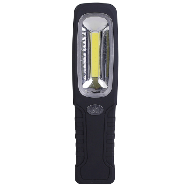 A black and red hands-free magnetic LED work light standing vertically on a rustic wooden workshop table with professional tools in the blurred background.