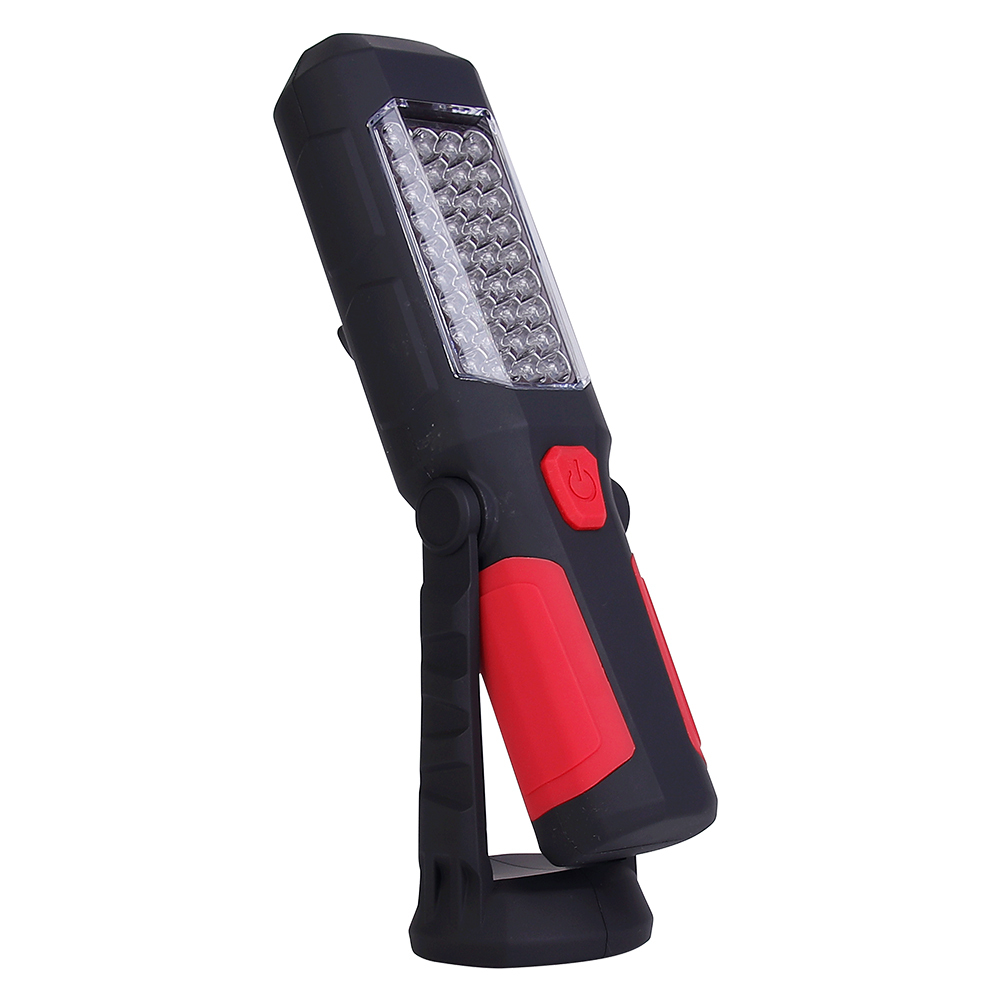 Side view of the multifunctional magnetic LED work light with its integrated stand bent backward on the rotating base.
