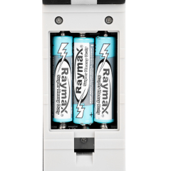 Close-up view of the battery compartment on the back of the LED work light loaded with three AAA batteries.