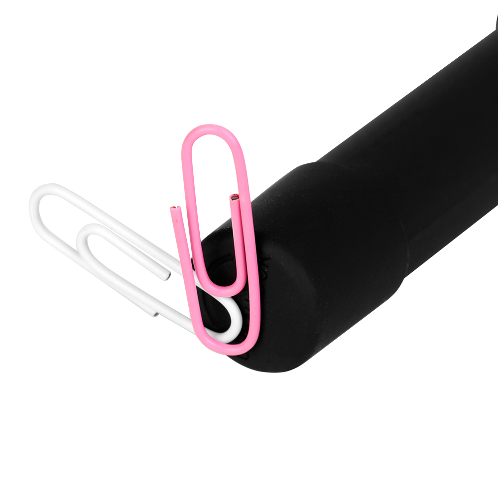 A demonstration view of the black penlight tip showing a small pink paperclip magnetically attached to the bottom base.
